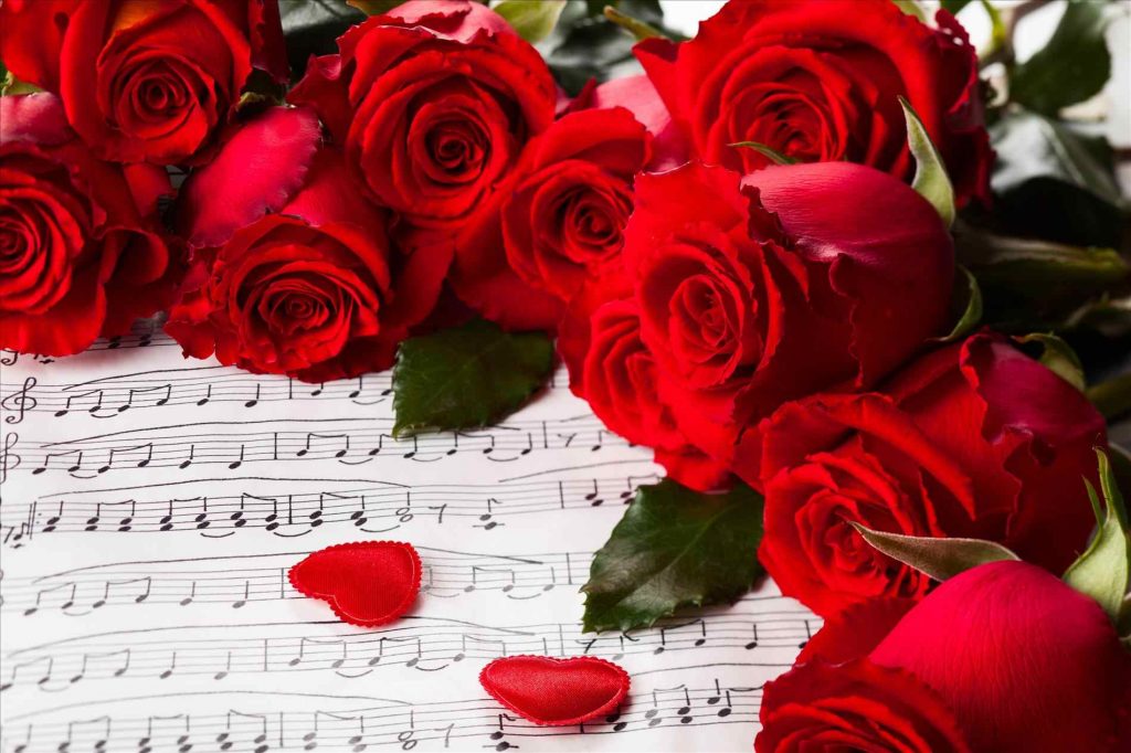 rose petals in heart shape on bed